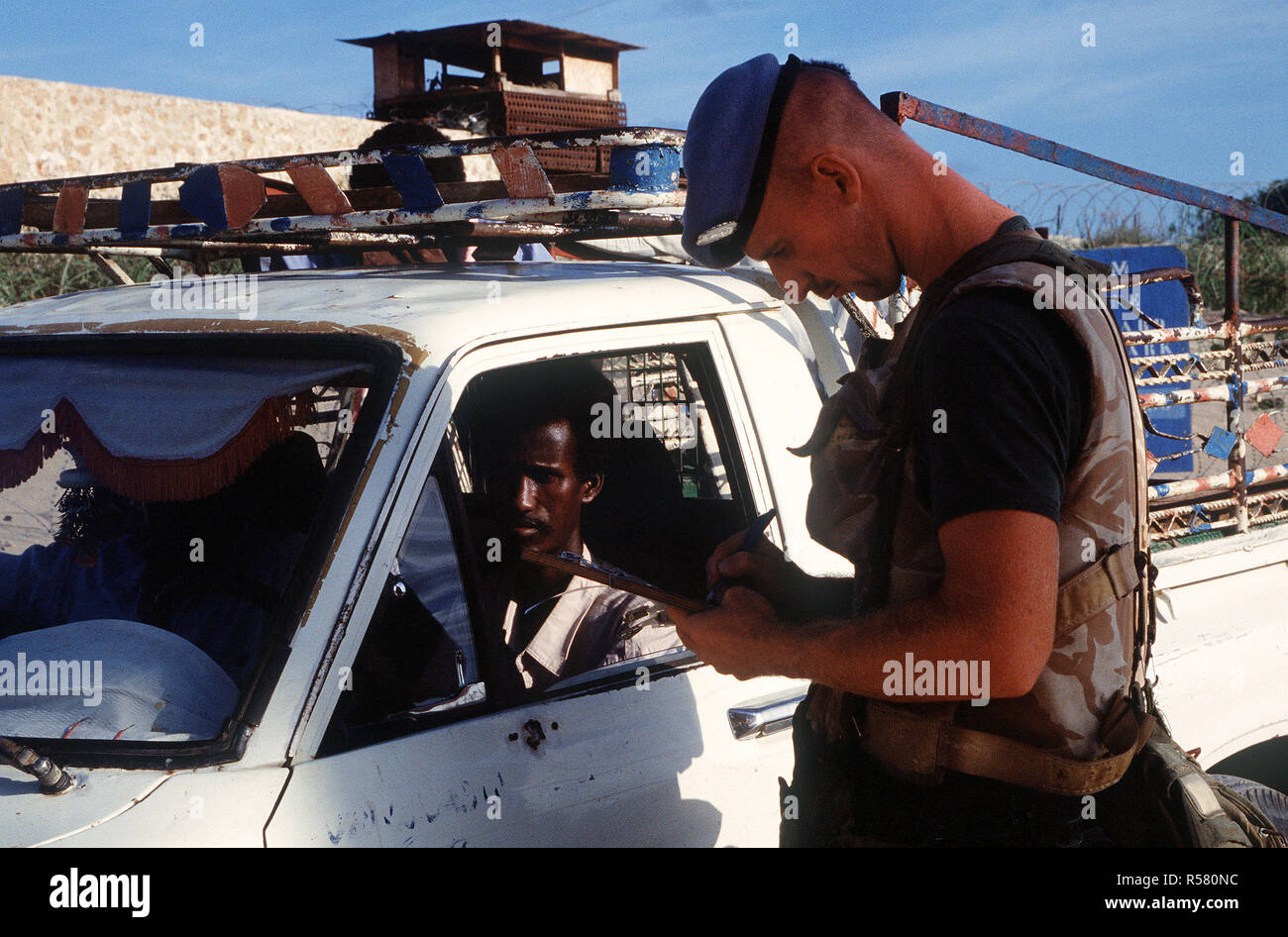 1993 - A Belgian soldier performs a security check on a vehicle trying to enter the compound in Kismayo.  The Belgian contingent is part of the United Nations Forces in Somalia in support of OPERATION CONTINUE HOPE. Stock Photo