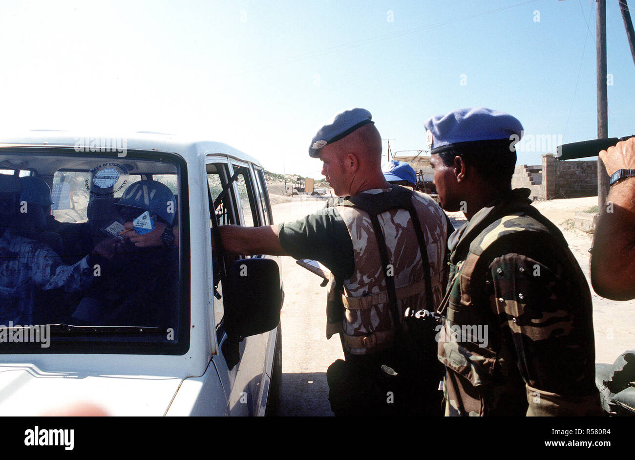 A Belgian soldier performs a security check on a vehicle trying to enter the compound in Kismayo.  The Belgian contingent is part of the United Nations Forces in Somalia in support of OPERATION CONTINUE HOPE. Stock Photo