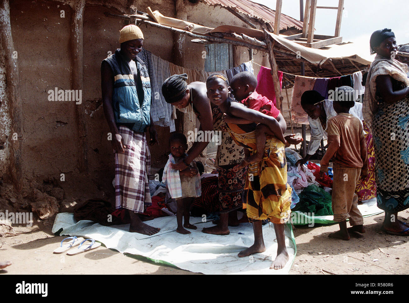 1993 - A little child tries on a shirt in the market in Mogambo village in Somalia during operation Continue Hope. Stock Photo