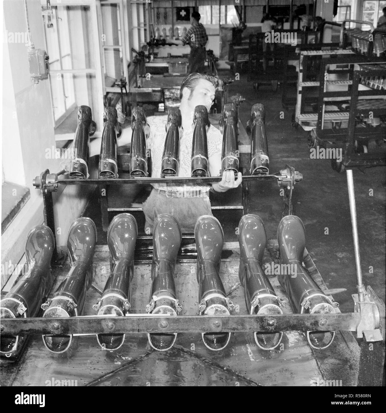 Finland History An employee stops rubber boots for vulcanization. ca