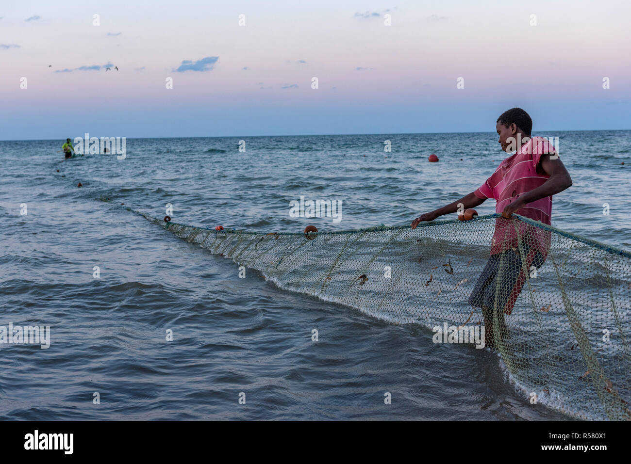 Fishermen haul out there nets in Mozambique. Stock Photo
