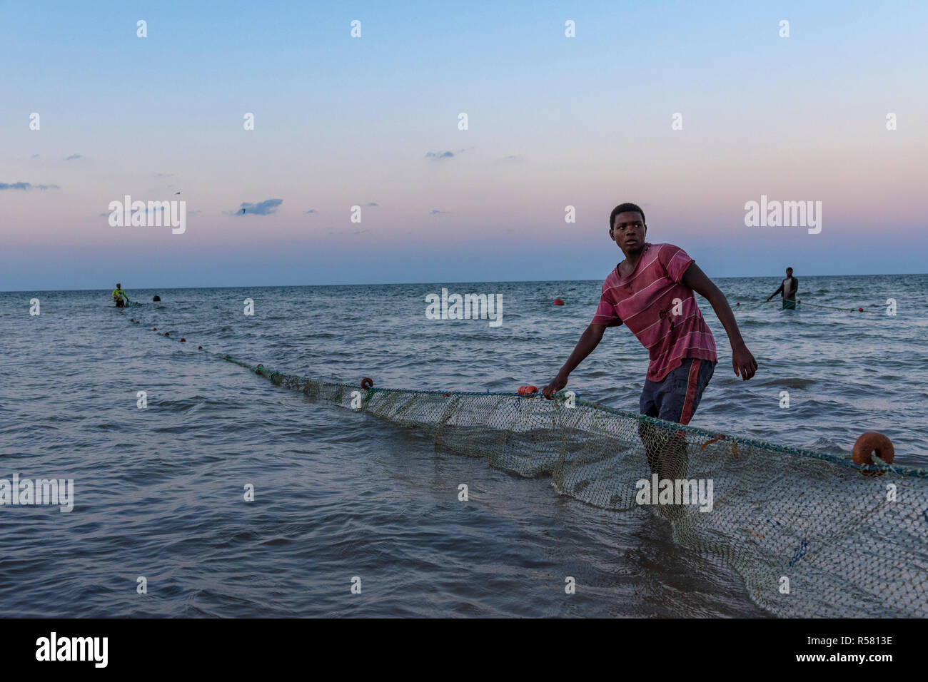 Fishermen haul out there nets in Mozambique. Stock Photo
