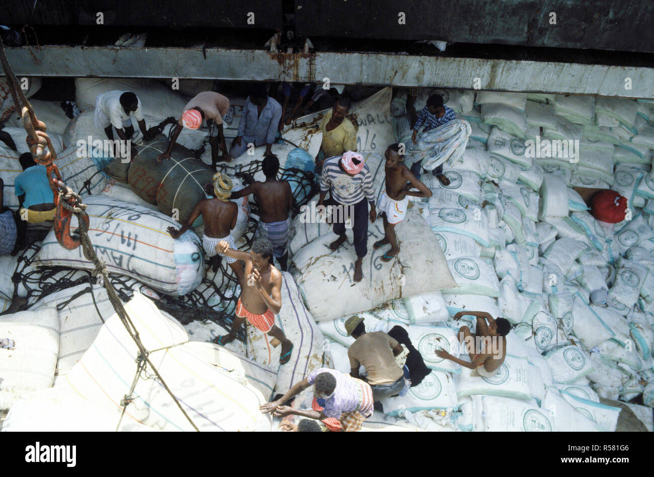 1993 - Rice and other relief supplies rest in the hold of a Saudi Arabian freighter as Somalis work to off-load at the seaport.  The Saudis are providing relief supplies to the Somali people. Stock Photo