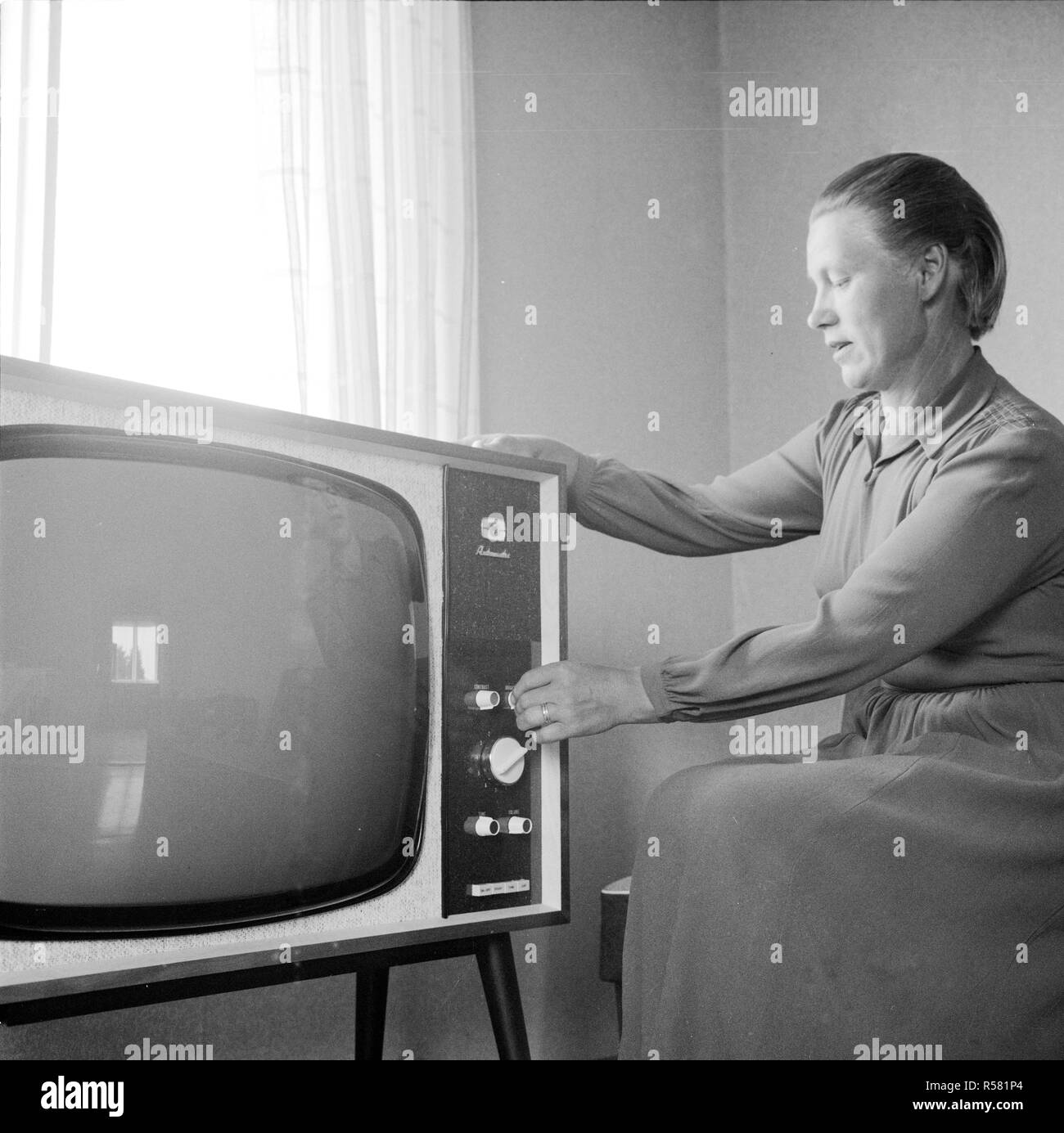 Finland History - Smallholder Lempi Kuikka with a TV-set she won from a  competition organized by Kuluttaja magazine. There is no picture on the  screen, as the Kuikkas' house didn't have electricity.