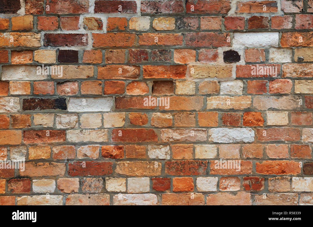 multicolor red, white and black multicolor old vintage brick wall texture as background Stock Photo