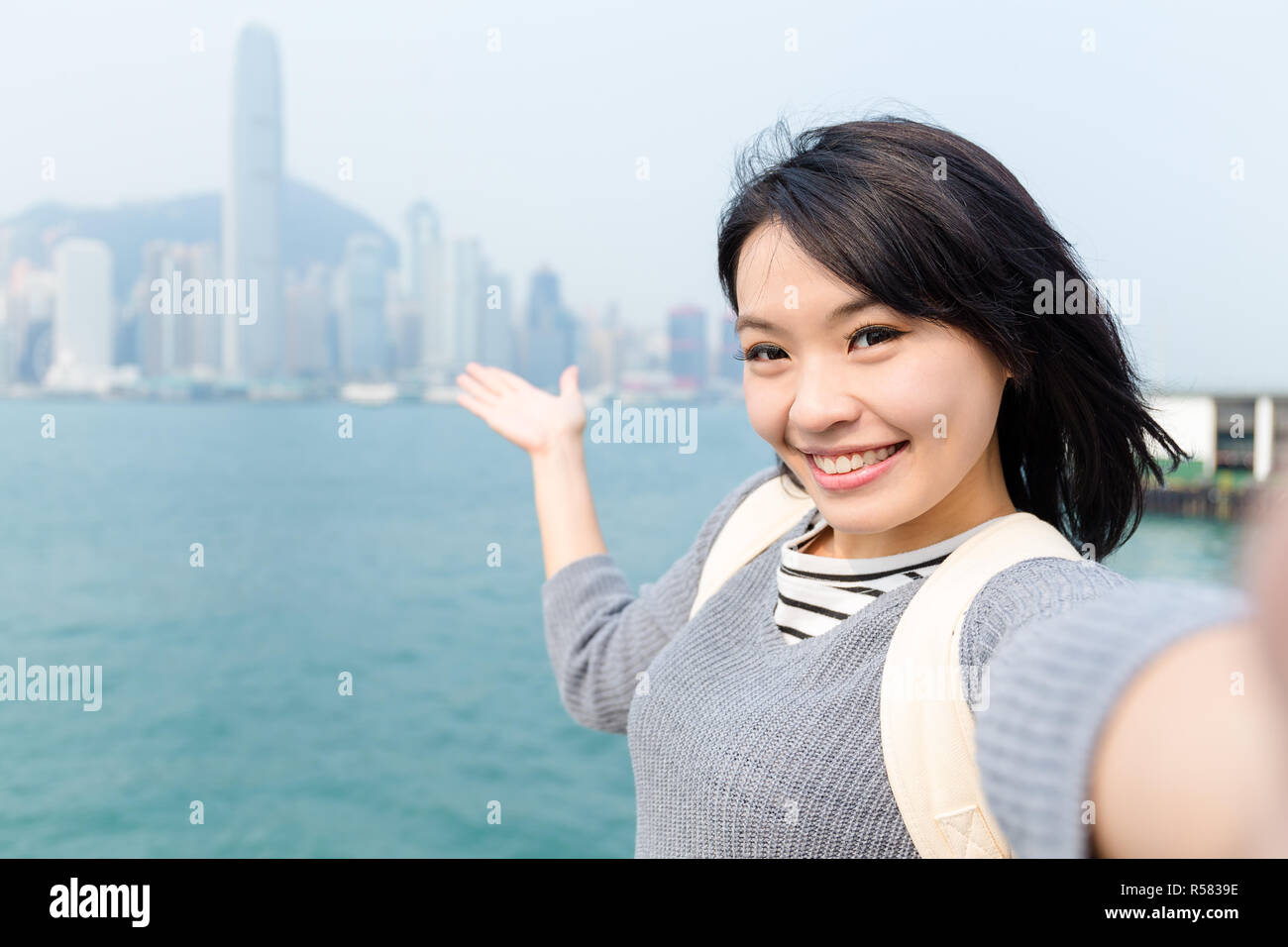 Woman take selfie and showing the skyline of Hong Kong Stock Photo - Alamy