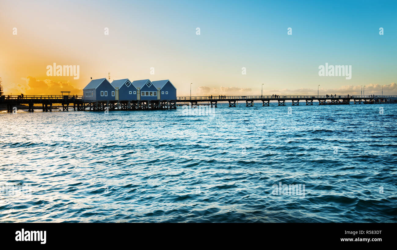 Beautiful sunset at wooden Busselton jetty in Western Australia - longest timber piled jetty in the southern hemisphere, with  tourists silhouettes Stock Photo