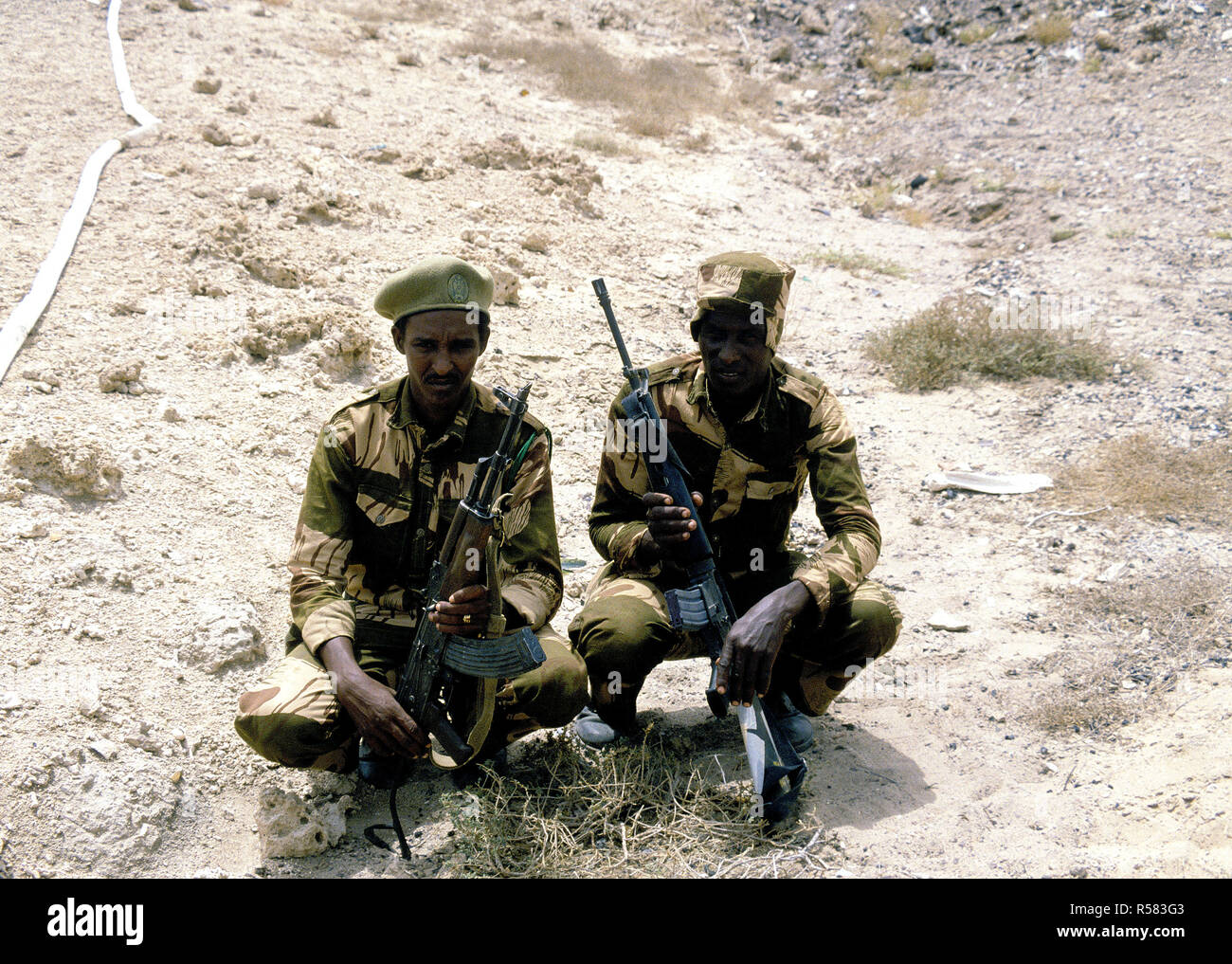 1993 - Two Somalian soldiers pose for a photo during Exercise EASTERN WIND '83, the amphibious landing phase of Exercise BRIGHT STAR '83.  The soldier on the right has an M16A1 rifle he borrowed from a US Marine, and the soldier on the left has an AKM 7.62 mm assault rifle. Stock Photo