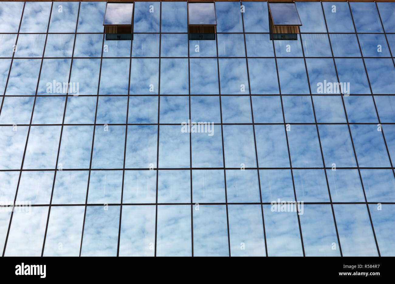 Cloudy sky reflection in business building glass Stock Photo - Alamy