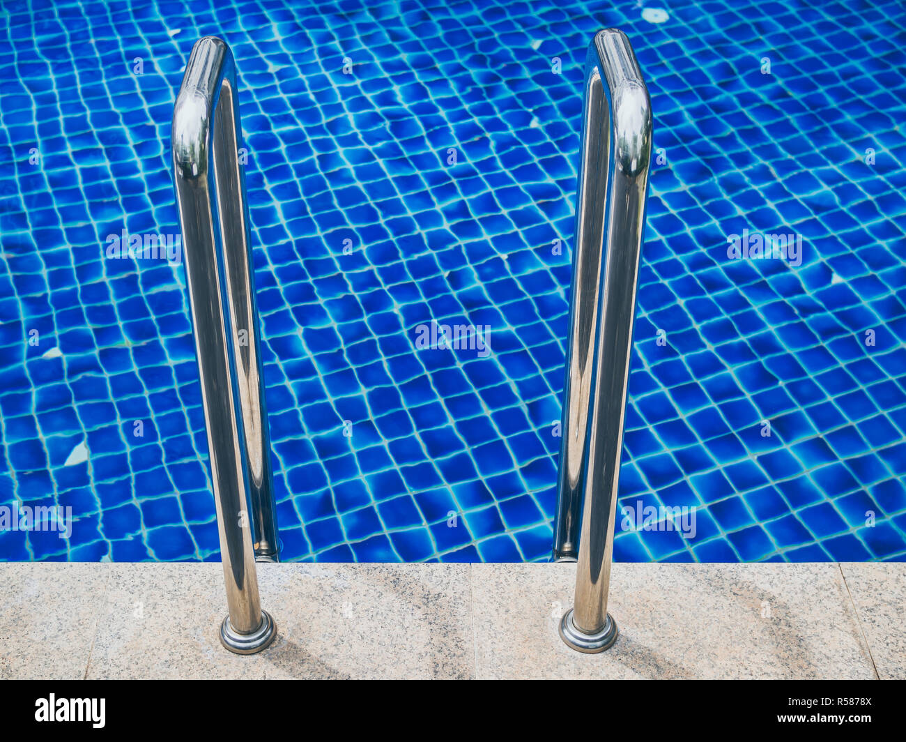 Grab bars ladder in swimming pool. Swimming pool stairs Stock Photo Alamy