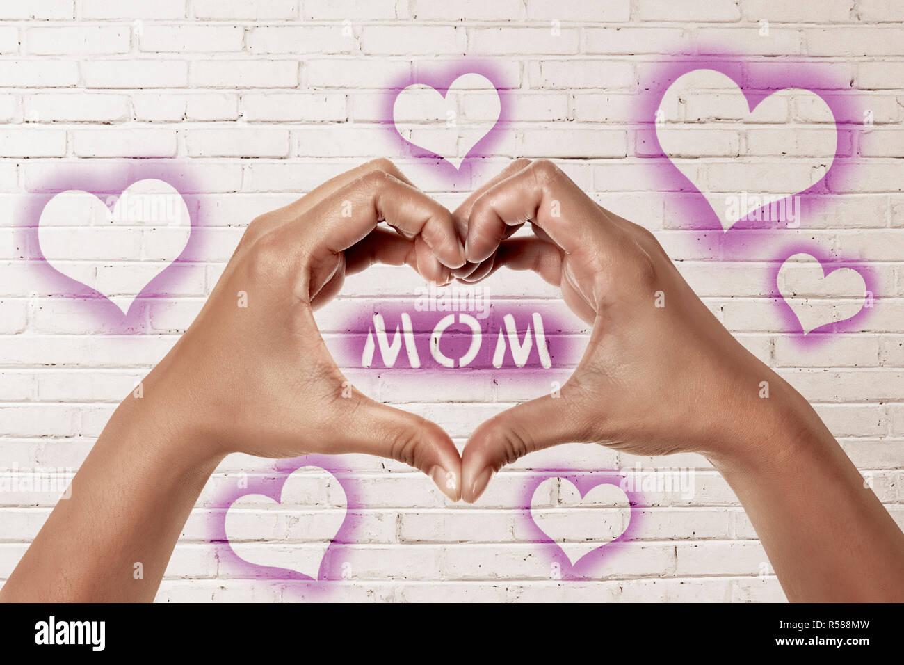 People hands in shape of heart with mom text Stock Photo - Alamy