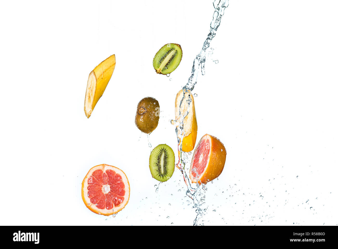 Fresh fruits falling in water splash, isolated on white background Stock Photo
