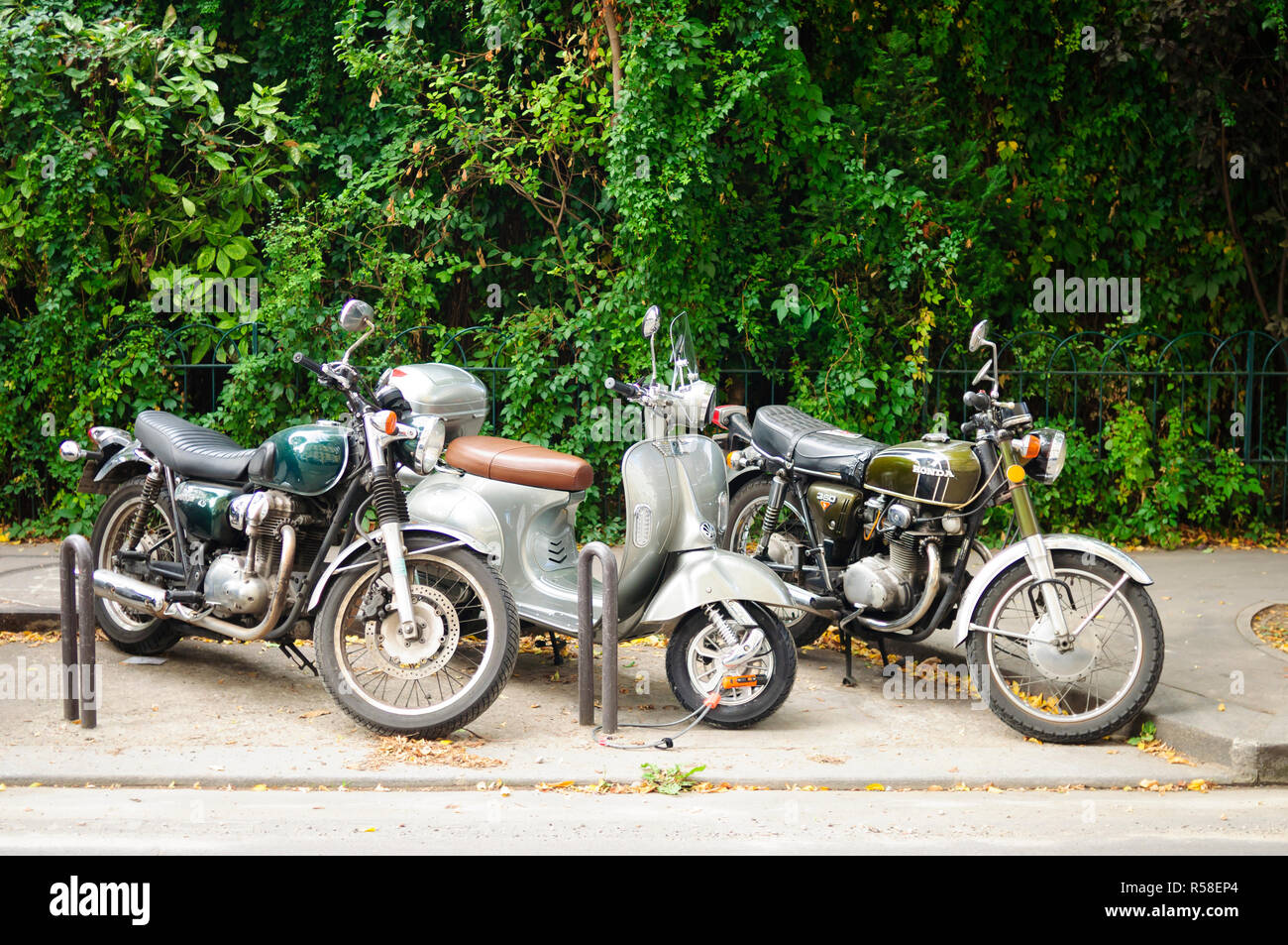 Paris, France, Vespa Motorscooters and others bikes Parked on Street Stock Photo