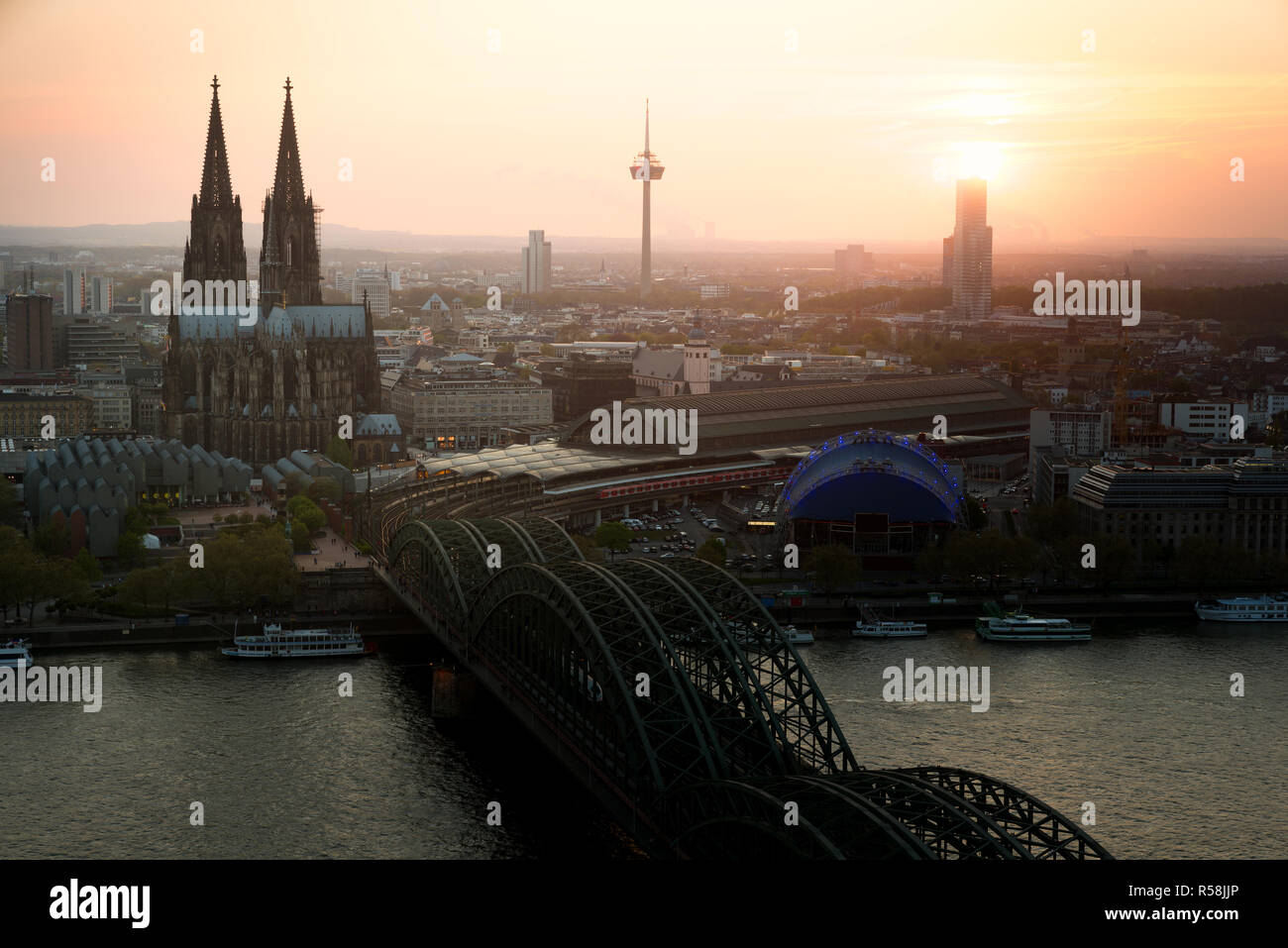 Image of Cologne with Cologne Cathedral with Rhine river and Hohenzollern  bridge during sunset time in Germany. Stock Photo