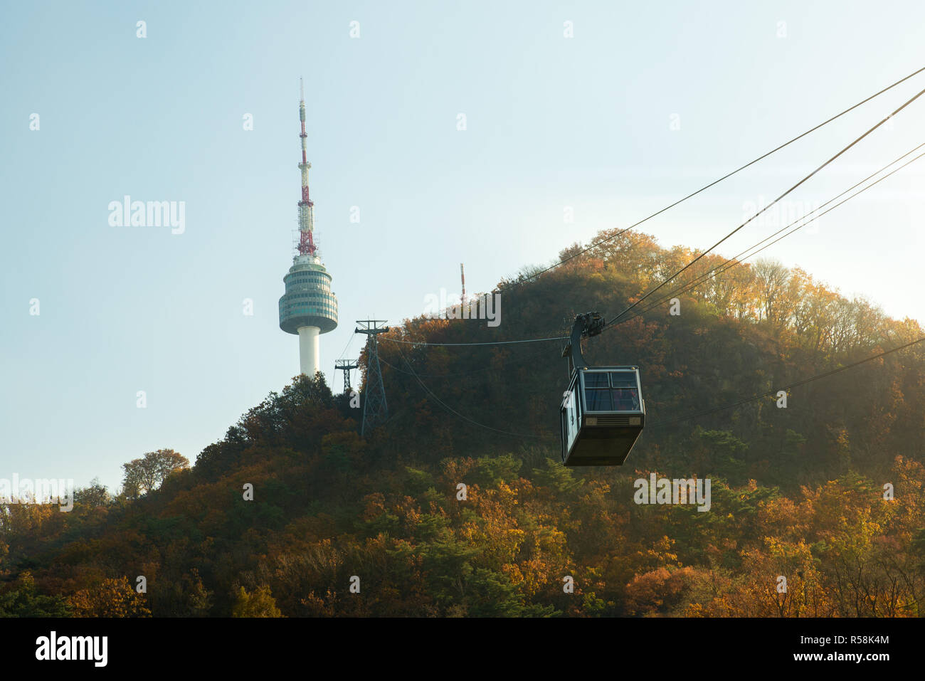 Namsan N Seoul Tower with the line of cable car at the sunset time in autumn at Seoul, South Korea. Stock Photo