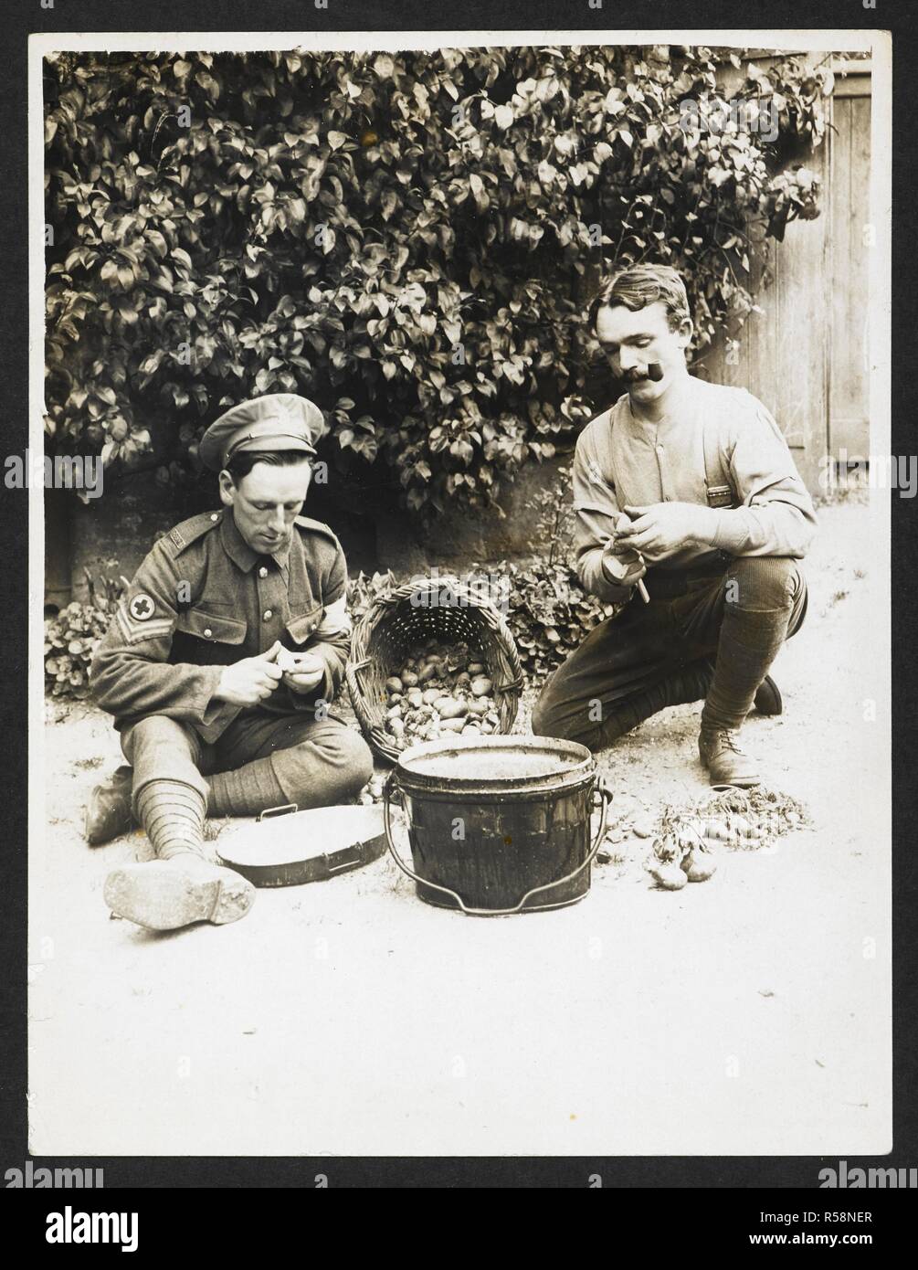 Red Cross orderlies at work [France]. Two orderlies peeling potatoes. 1915.  Record of the Indian Army in Europe during the First World War. 20th  century, 1915. Gelatin silver prints. Source: Photo 24/(321).