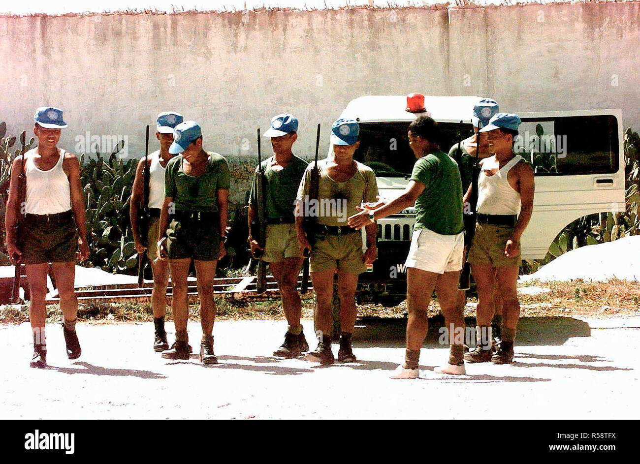 Eight Malaysian Peacekeeping Soldiers stand in formation to practice drill inside their headquarters located near the airport in Mogadishu.  They all carry British made 7.62mm Enfield L1A1 rifles over their shoulder.  The Malaysians are assigned to the task force that is in direct support of Operation Restore Hope. Stock Photo