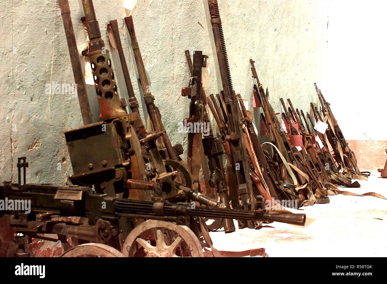 1993 - Confiscated Somali weapons at checkpoint Condor in Marka, Somalia.  They are mostly small arms and crew weapons that are lined up against the wall of a building. Stock Photo