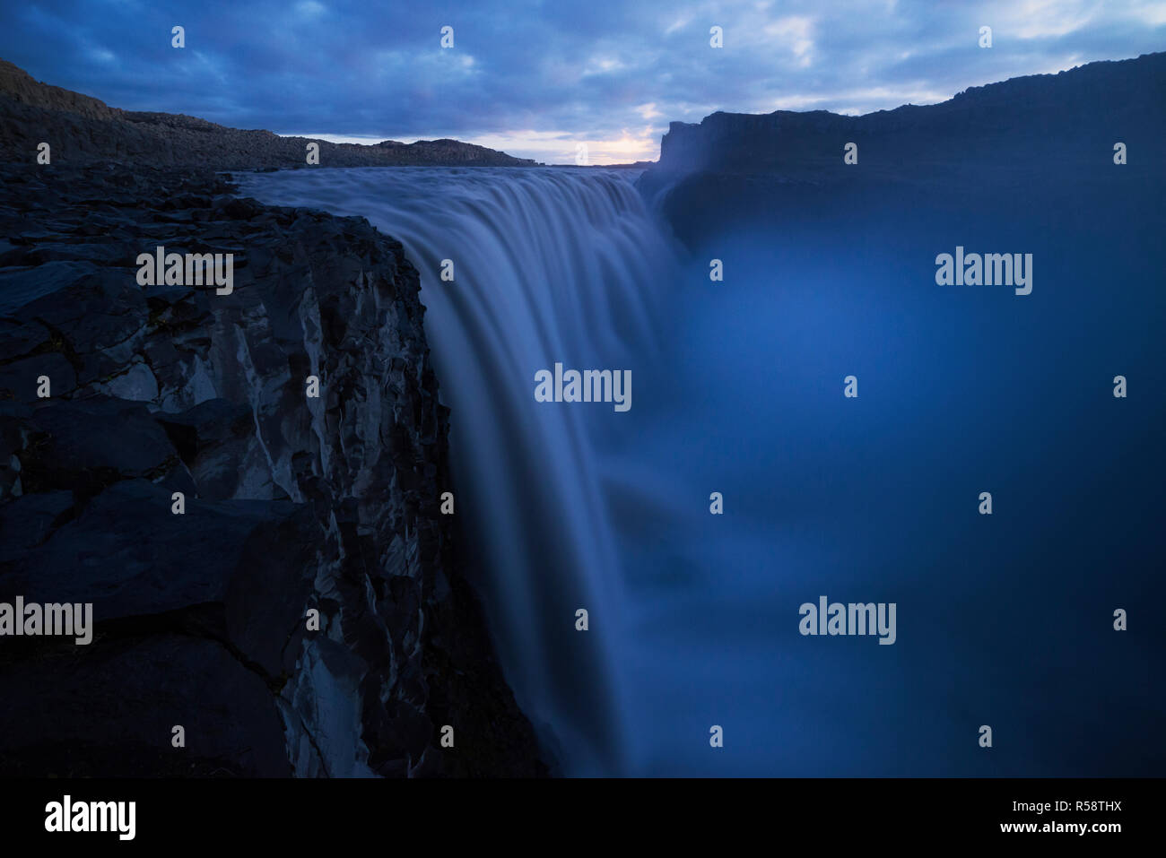 Moonset over roaring waterfall, Dettifoss, Iceland Stock Photo