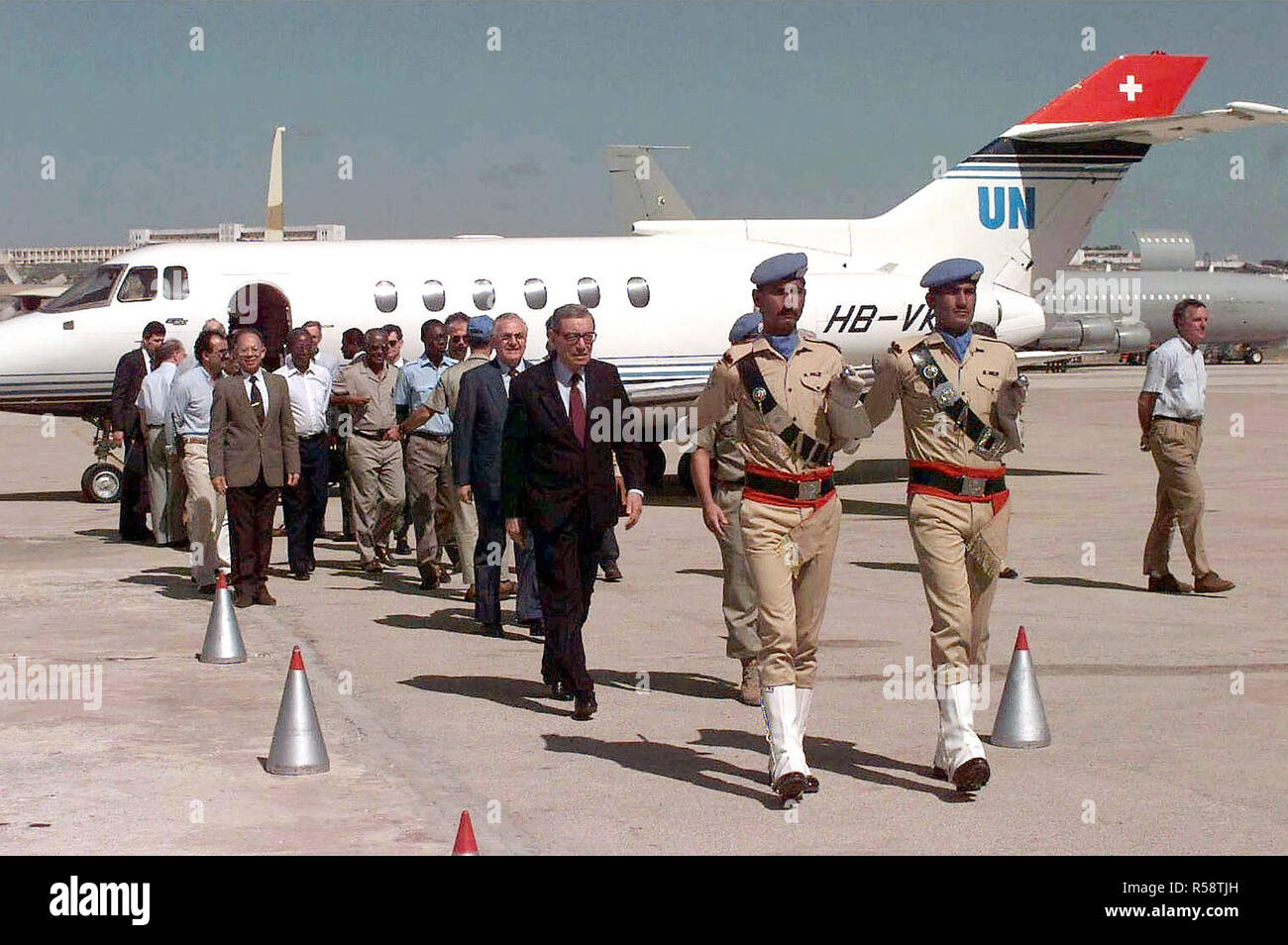 Straight on shot of UN Secretary GEN Boutros Burtros-Ghali as he walks with a Pakistani Military escort away from his United Nations Lear Jet at Mogadishu Airport. Other United Nations dignitaries walk behind the Secrectary General. The Secretary General is in Somalia for meetings and briefings on Operation Restore Hope. Stock Photo