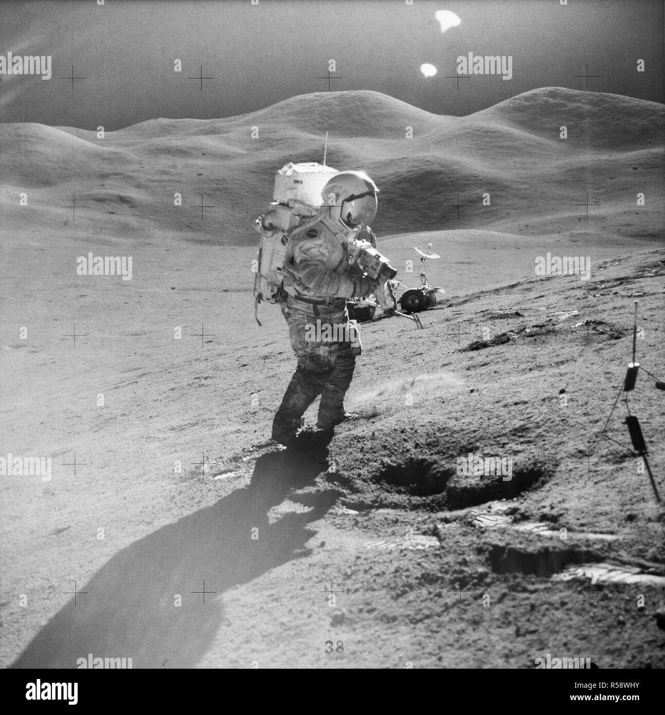 (31 July-2 Aug. 1971) --- Astronaut David R. Scott, commander, standing on the slope of Hadley Delta, uses a 70mm camera during Apollo 15 extravehicular activity (EVA) on the lunar surface. Stock Photo