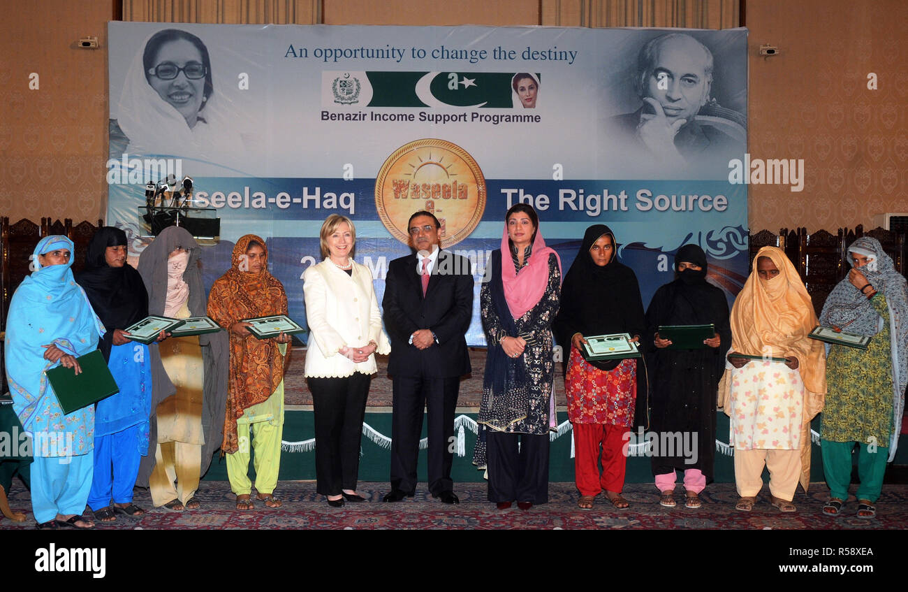 U.S. Secretary of State Hillary Rodham Clinton, Pakistan President Asif Ali Zardari, and chairperson of Benazir Income Support Program Farzana Raja with the monthly lottery winner female recipients of the program at the Presidential Palace in Islamabad Stock Photo