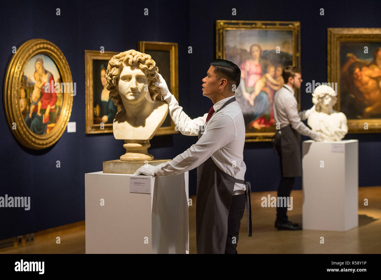 A Christie's art handler with a bust of Alexander the Great, dated to