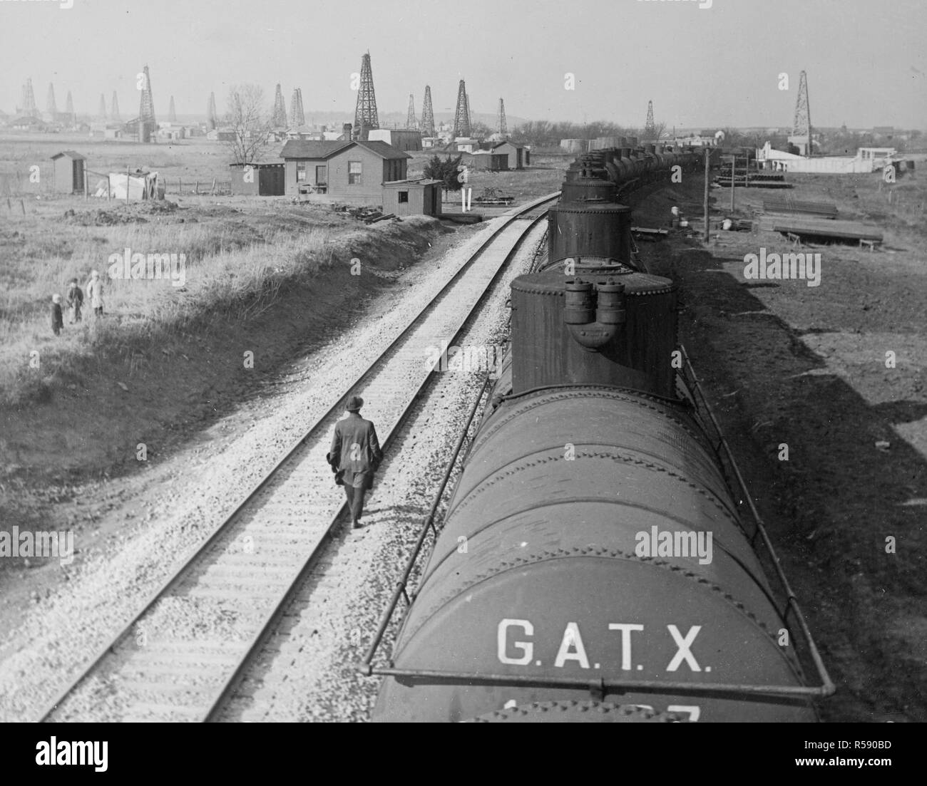 A steel tank train conveying cured oil from the wells in the Yale Field in Oklahoma to refinery. Each car contains 10, 000 gallons. The annual production of mineral oil in the United States is approximately eleven billion gallons, or 65 percent of the world's output. March 25, 1918 Stock Photo