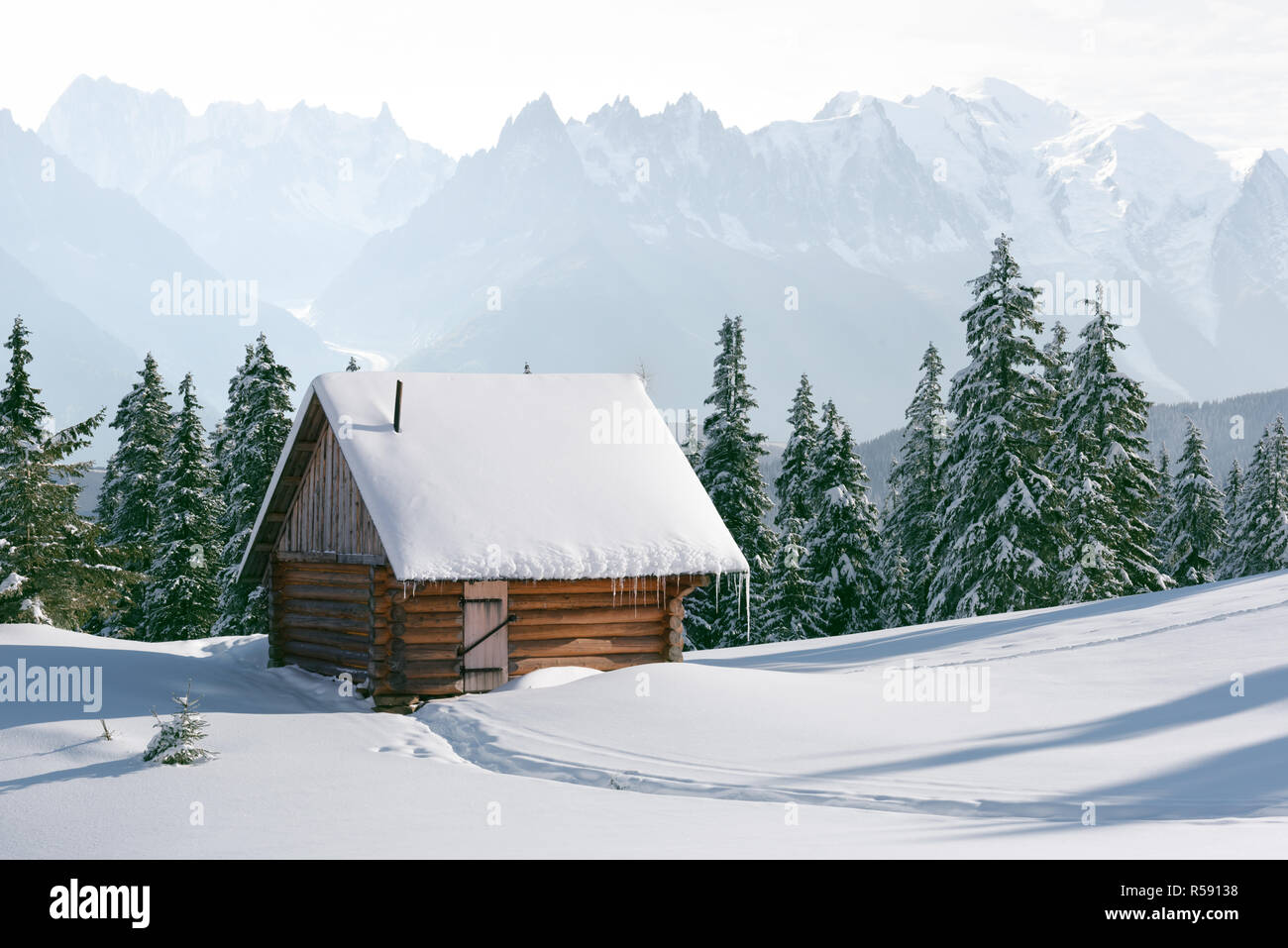Fantastic winter landscape with wooden house in snowy mountains ...