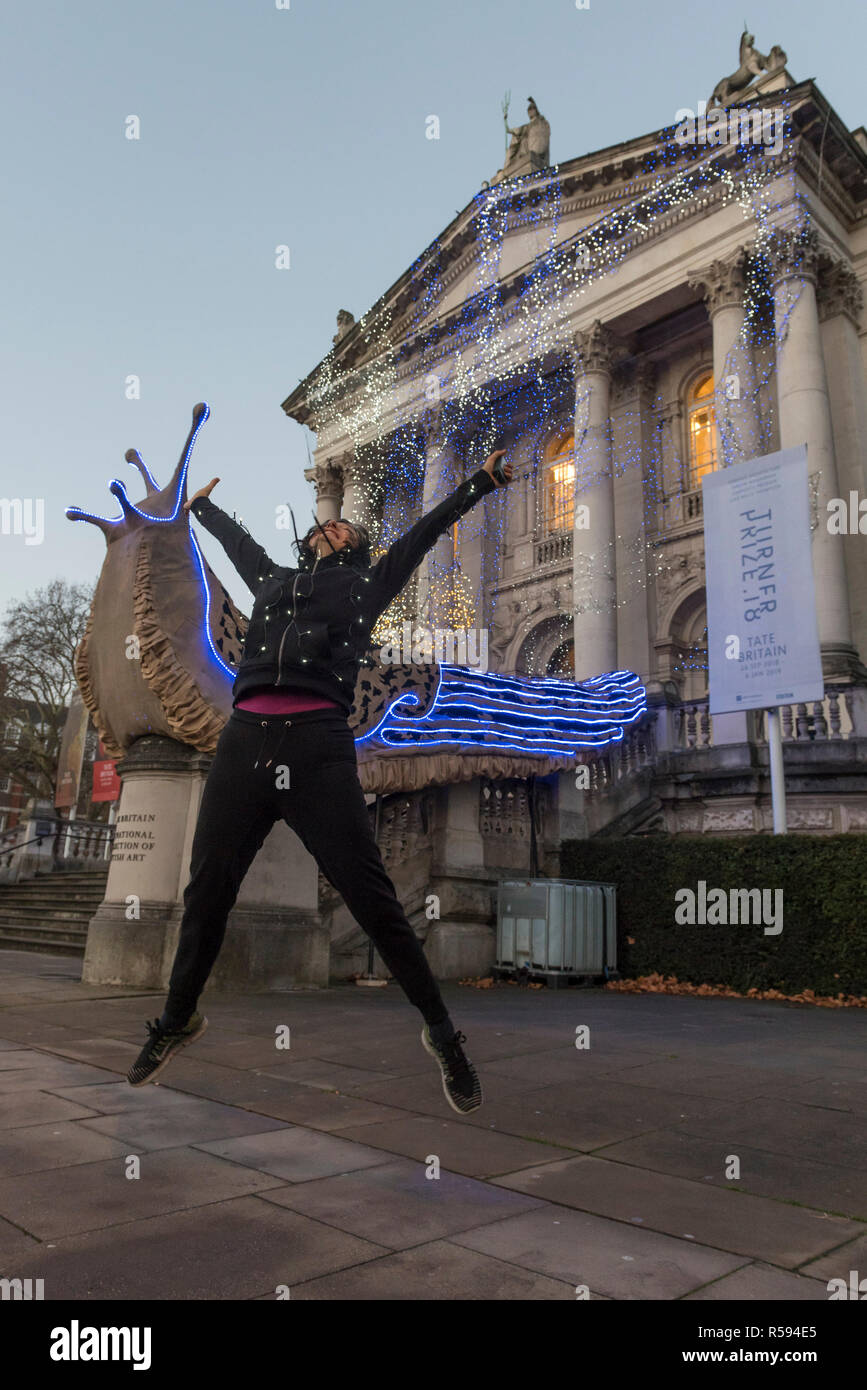 London, UK.  30 November 2018. Turner Prize nominated artist Monster Chetwynd poses in front of her new Tate Britain Winter Commission.  The artist, formerly known as 'Marvin Gaye' and 'Spartacus', has transformed Tate Britain’s iconic Neo-Classical façade to mark the winter season with a new piece inspired by the winter solstice, involving a dazzling light display and elements of sculpture.  Winter Commission 2018: Monster Chetwynd will be switched on daily from 1st December 2018 - 28 February 2019.  Credit: Stephen Chung / Alamy Live News Stock Photo