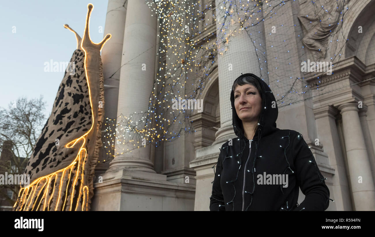 London, UK.  30 November 2018. Turner Prize nominated artist Monster Chetwynd poses in front of her new Tate Britain Winter Commission.  The artist, formerly known as 'Marvin Gaye' and 'Spartacus', has transformed Tate Britain’s iconic Neo-Classical façade to mark the winter season with a new piece inspired by the winter solstice, involving a dazzling light display and elements of sculpture.  Winter Commission 2018: Monster Chetwynd will be switched on daily from 1st December 2018 - 28 February 2019.  Credit: Stephen Chung / Alamy Live News Stock Photo
