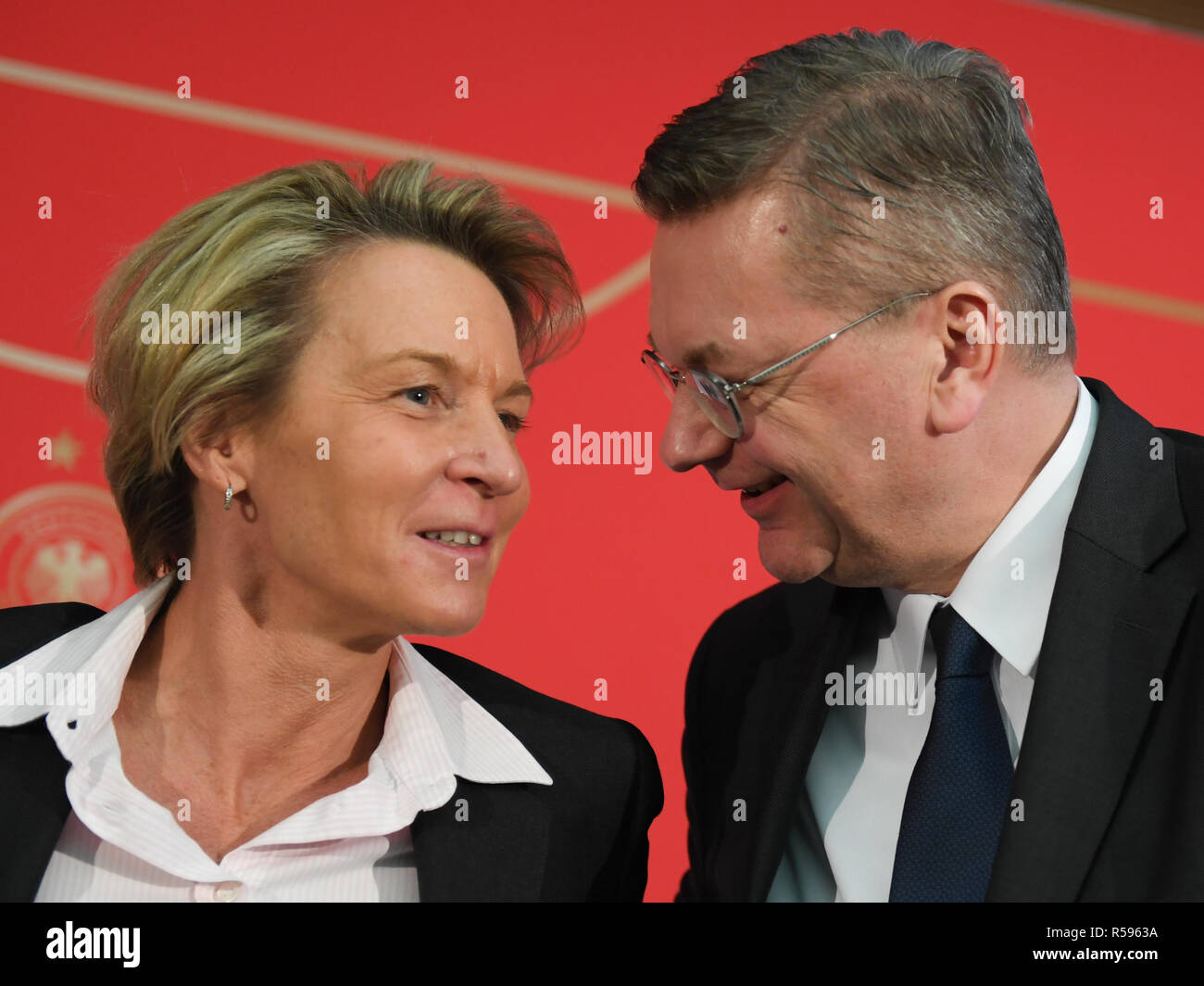 30 November 2018, Hessen, Frankfurt/Main: Martina Voss-Tecklenburg, the new national coach of the women's national team, and Reinhard Grindel, President of the German Football Association (DFB), talk to each other after a press conference at the DFB headquarters. Voss-Tecklenburg was previously coach of the Swiss women's national team and is the successor to Horst Hrubesch. Photo: Arne Dedert/dpa Stock Photo
