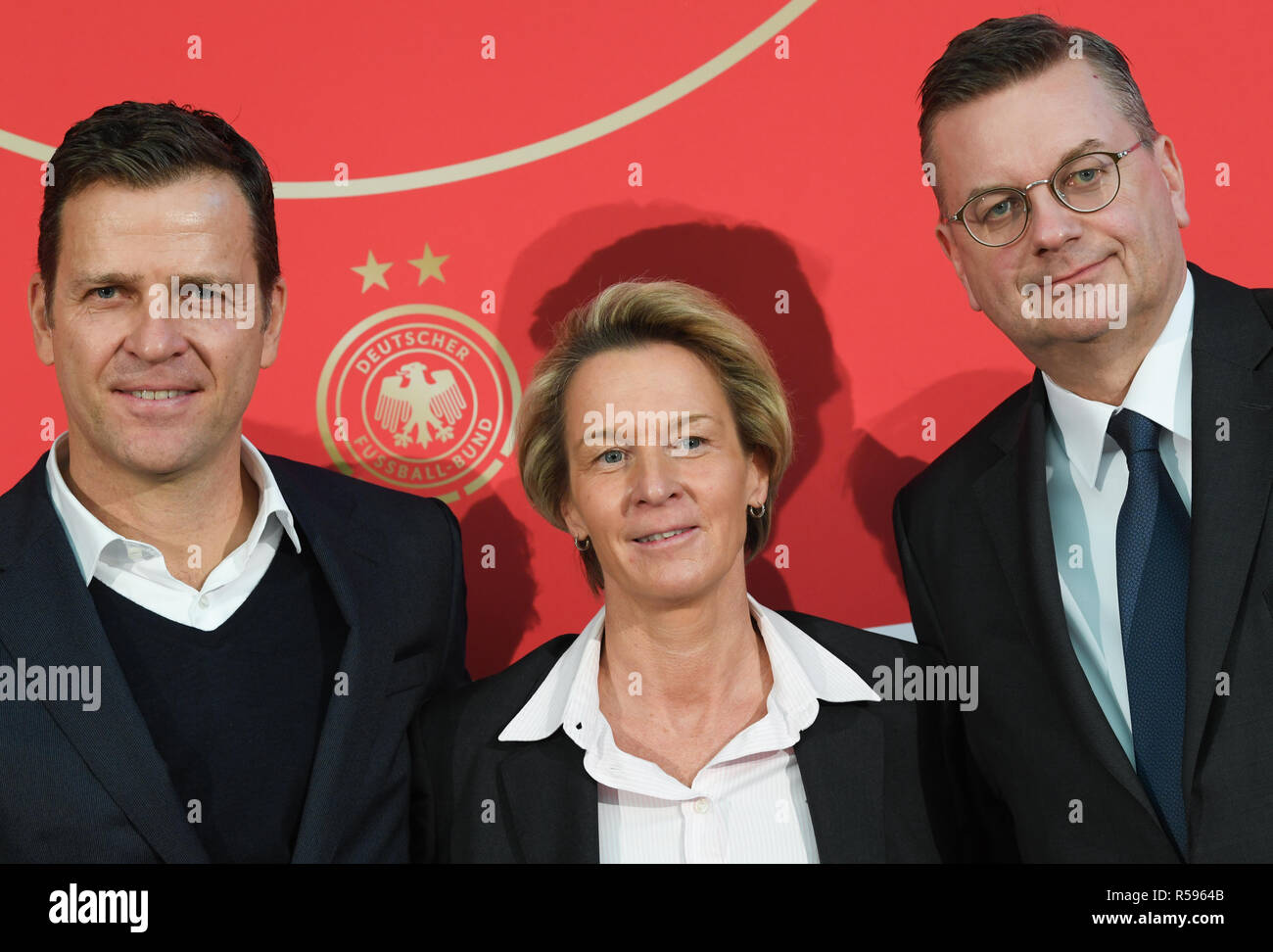 30 November 2018, Hessen, Frankfurt/Main: Oliver Bierhoff (l), DFB Director National Teams, and Reinhard Grindel, President of the German Football Association (DFB), will take part in the press conference to present Martina Voss-Tecklenburg, the new national coach of the women's national team, at the DFB headquarters. Voss-Tecklenburg was previously coach of the Swiss women's national team and is the successor to Horst Hrubesch. Photo: Arne Dedert/dpa Stock Photo