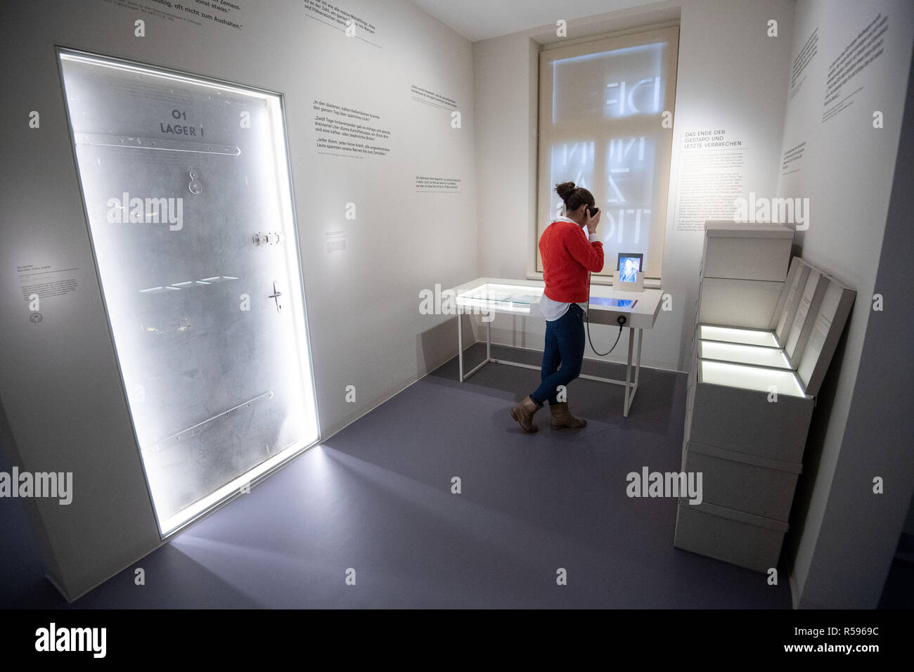 30 November 2018, Baden-Wuerttemberg, Stuttgart: A young woman stands during a press appointment in the permanent exhibition of the memorial place "Hotel Silber". After an almost demolition, long planning and several postponements, the former headquarters of the Secret State Police (Gestapo) is opened on 04 December as a "place of historical-political learning". Photo: Marijan Murat/dpa Stock Photo