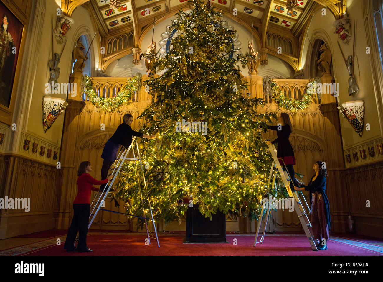 Windsor, UK. 30th Nov, 2018. The State Apartments at Windsor Castle have been decorated with glittering Christmas trees and twinkling lights for Christmas. Seen here in St George's Hall a striking 20ft Nordmann Fir tree from Windsor Great Park dressed in gold. A 15ft Christmas tree also appears in the Crimson Drawing Room. Credit: Mark Kerrison/Alamy Live News Stock Photo
