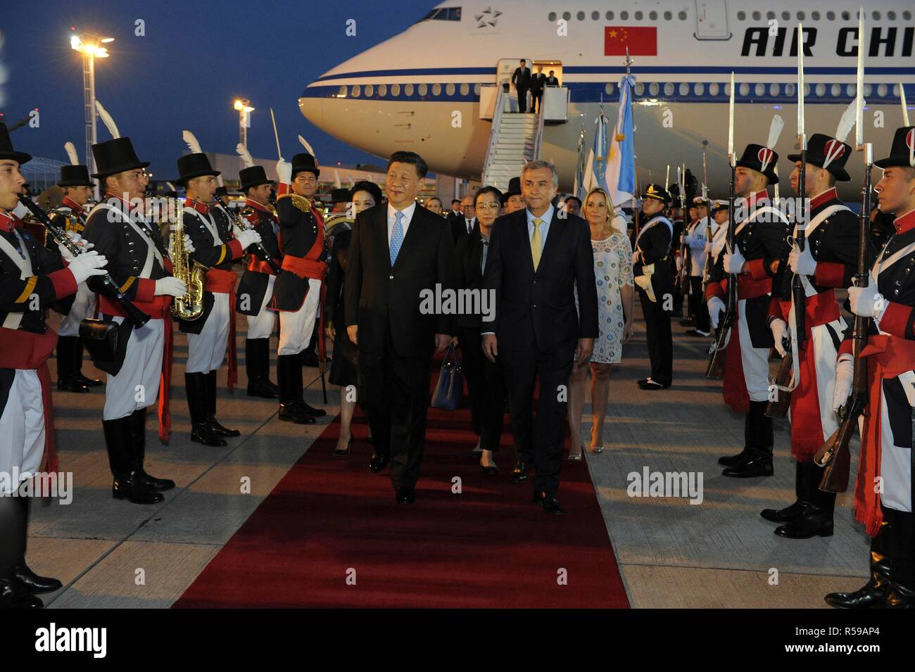 Chinese President Xi Jinping is escorted by Argentine President Mauricio Macri, right, as they arrive at the Ministro Pistarini international airport November 29, 2018 in Buenos Aires, Argentina. Xi will join other world leaders in the Group of 20 industrialized nations Summit meeting. Stock Photo