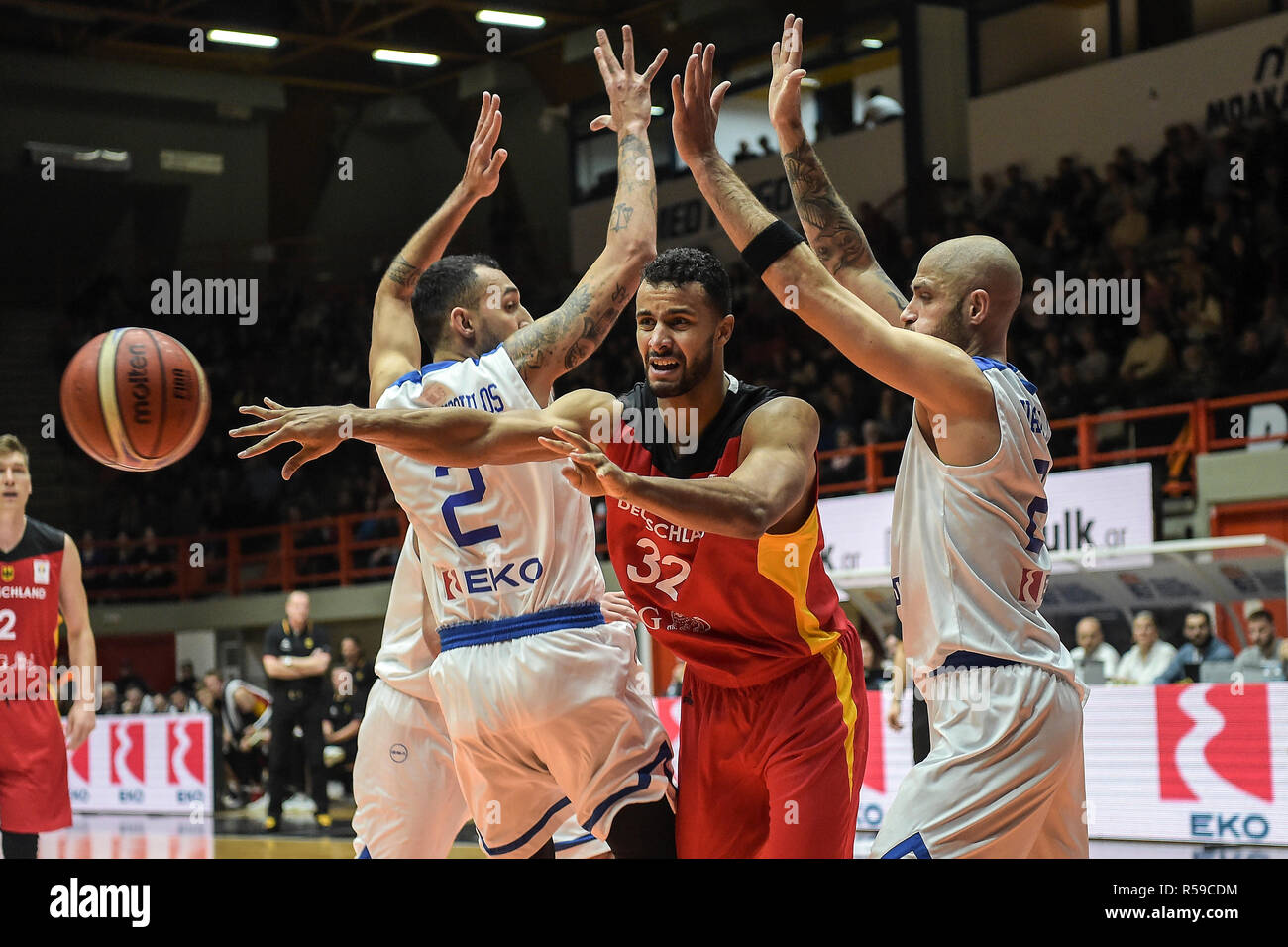 Patra, Greece. 30th Nov, 2018. Basketball: World Cup qualification, Greece  - Germany, Europe, 2nd round, Group L, 3rd matchday: German Johannes  Thiemann (M) is pressed by the Greeks Panagiotis Vasilopoulos (r) and