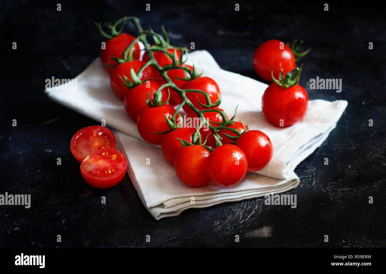 Cherry tomatoes on a dark background Stock Photo - Alamy