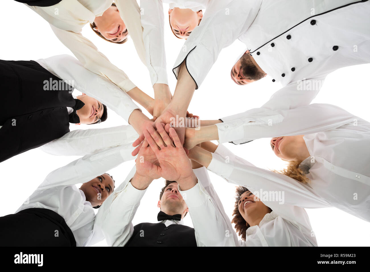 Multiracial Restaurant Staff Stacking Hands Stock Photo