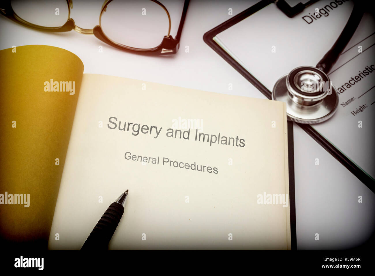 Titled book Surgery and implants general procedures along with medical equipment, conceptual image Stock Photo