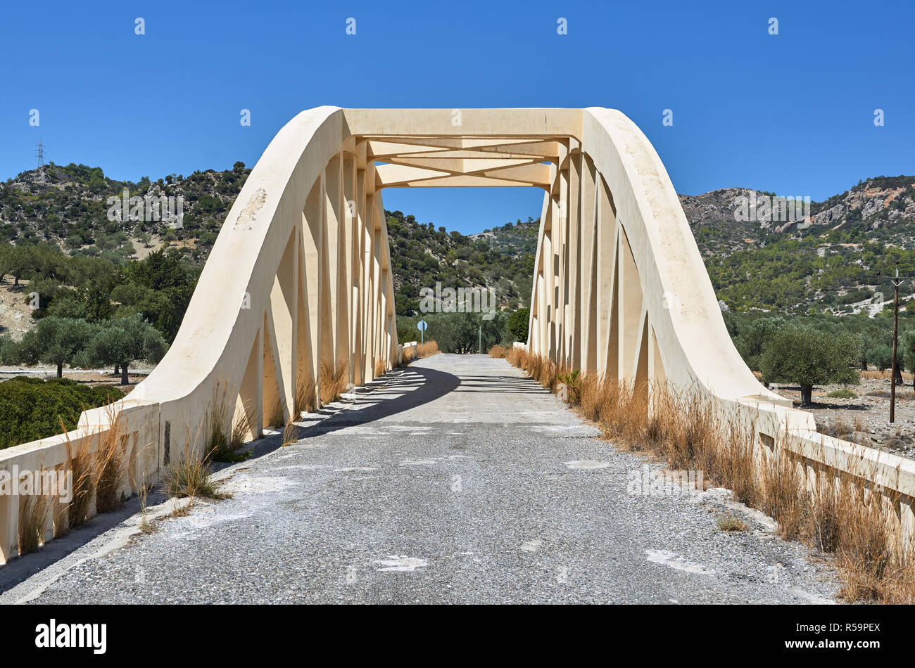 A road arched bridge over a dried river on the island of Rhodes Stock Photo