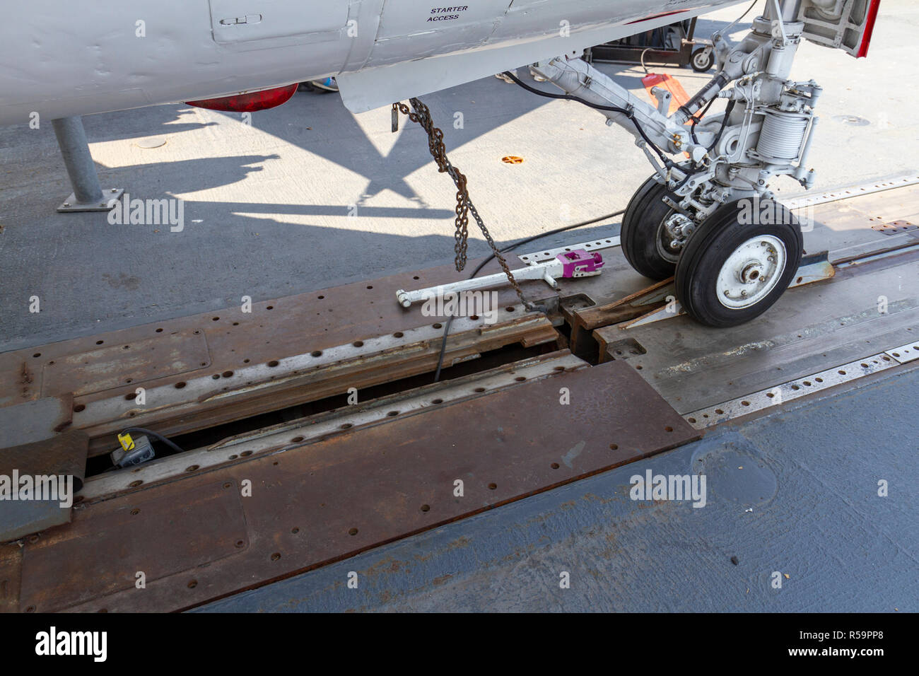 Front wheel of an aircraft attached to the steam catapult device on the