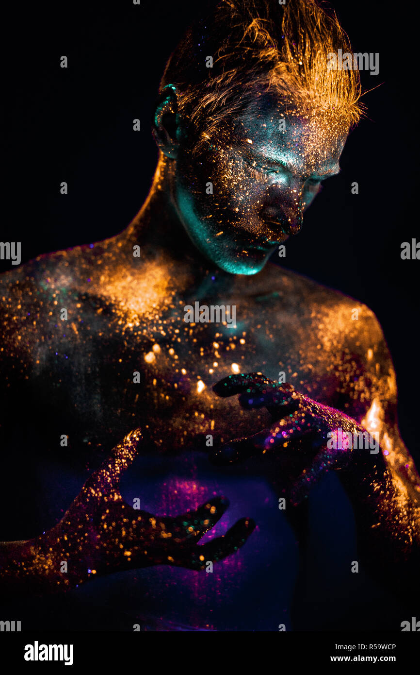 Portrait of a man painted in fluorescent UV colors Stock Photo - Alamy