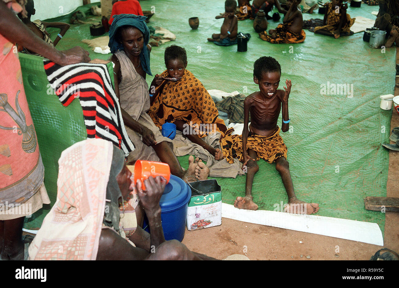 Somali refugees are fed at an aid station set up during Operation Restore Hope relief efforts. Stock Photo