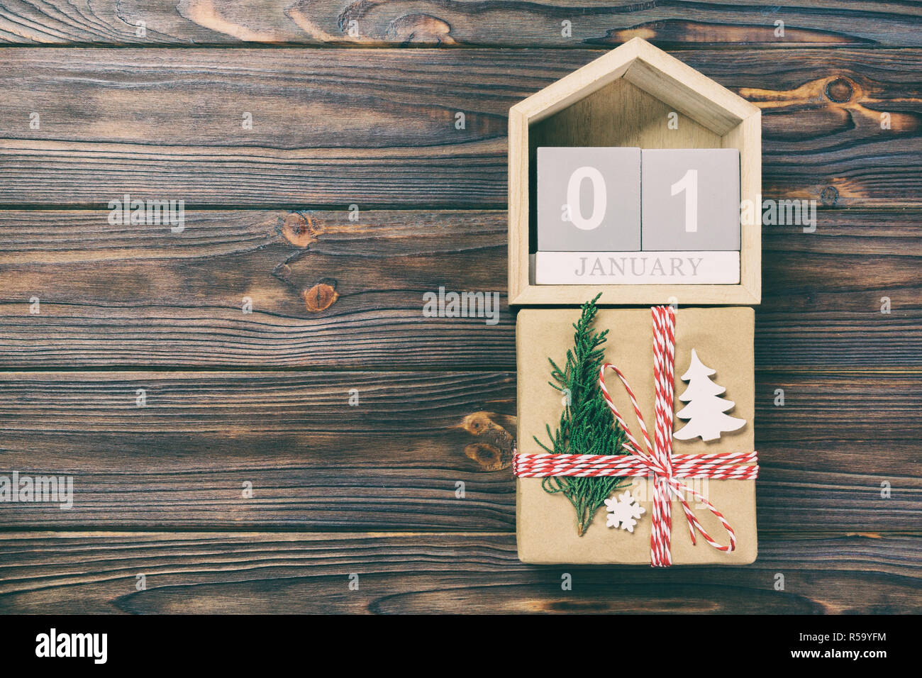 Box With January Calendar with date 1 january and gift boxes on color background ...