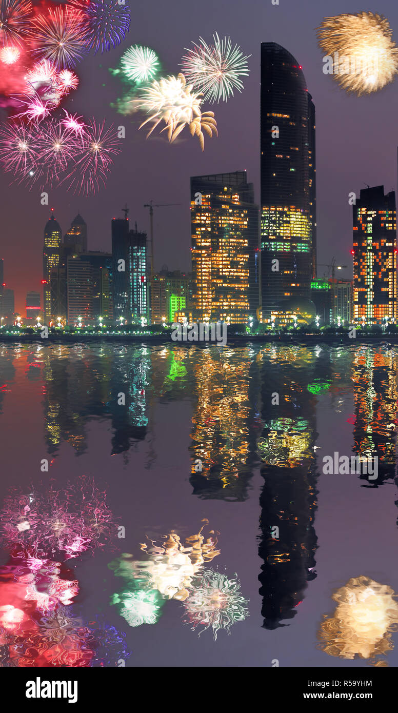 Abu Dhabi with skyscrapers against fireworks in United Arab Emirates