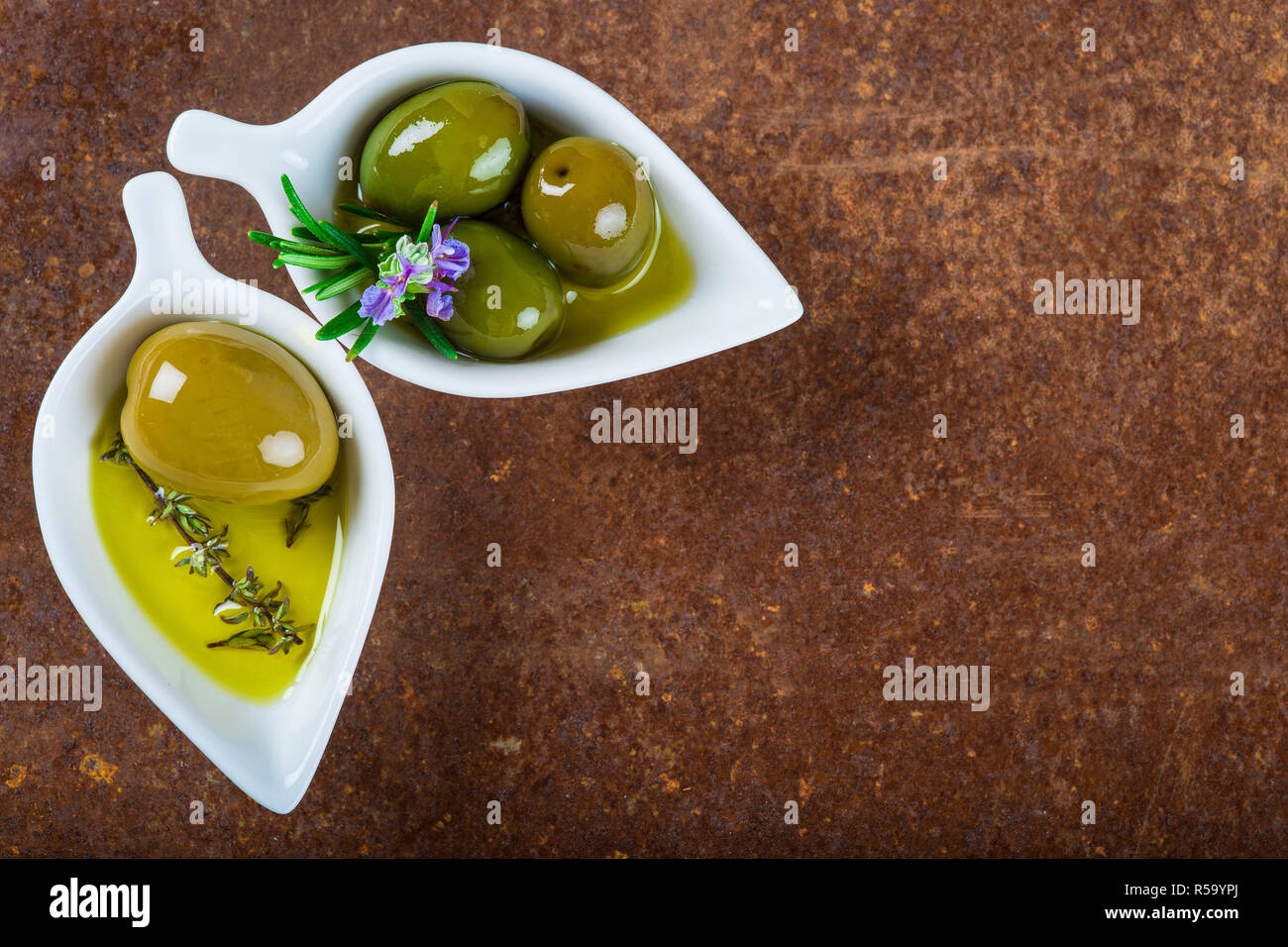 Extra virgin olive oil and green olives Stock Photo - Alamy