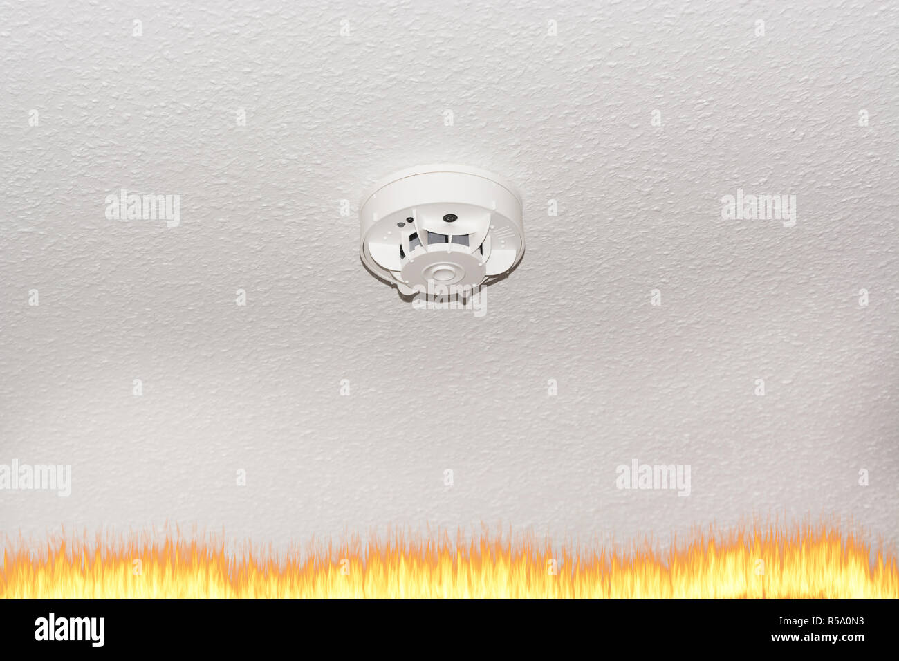 smoke detector on the ceiling and smoke. Stock Photo