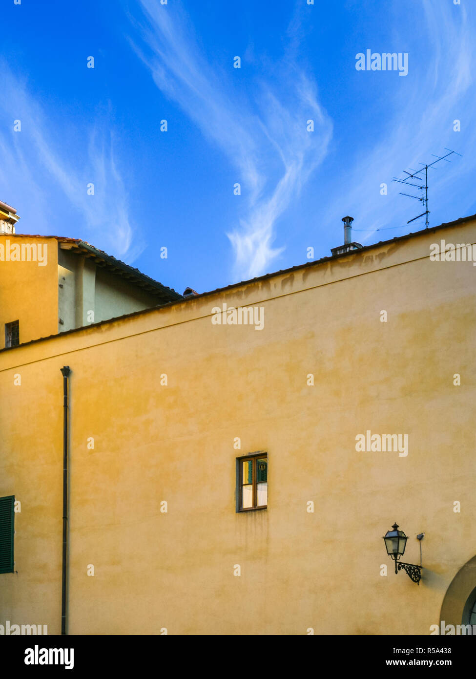 yellow urban house under blue sky in Florence Stock Photo - Alamy
