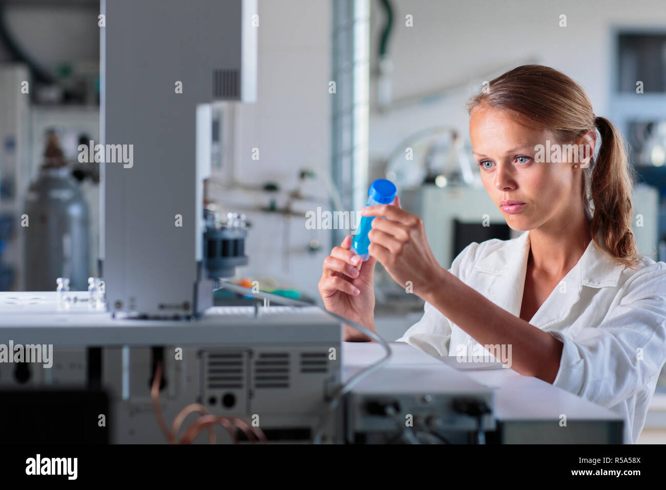 Portrait of a female researcher doing research in a lab, using a tablet computer for data collection and visualization(shallow DOF  color toned image) Stock Photo